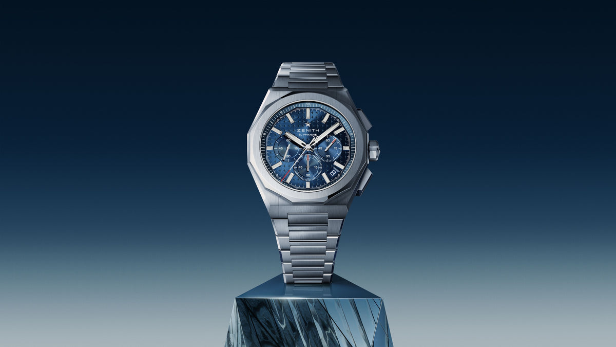 Zenith Defy Skyline Chronograph with blue dial on steel bracelet, displayed on a sculpted plinth